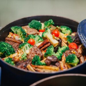 Vibrant dish of broccoli, beef, and veggies in a blue pan, perfect for dinner or lunch.